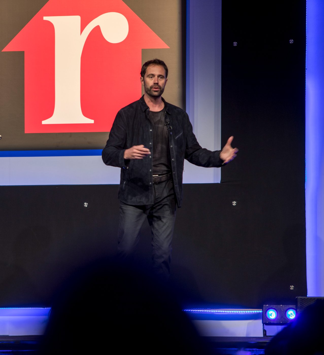 Garry Creath speaking on stage at a Realtor.com event